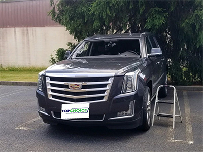 Black SUV Cadillac before Top Choice AutoGlass repair